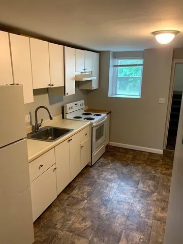 a kitchen with a stove a sink and a refrigerator