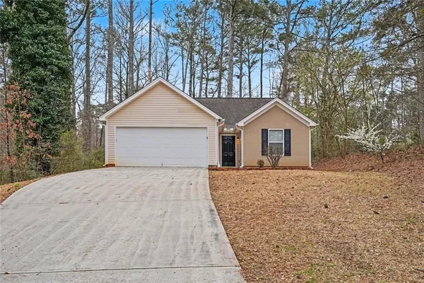 a front view of house with yard and trees
