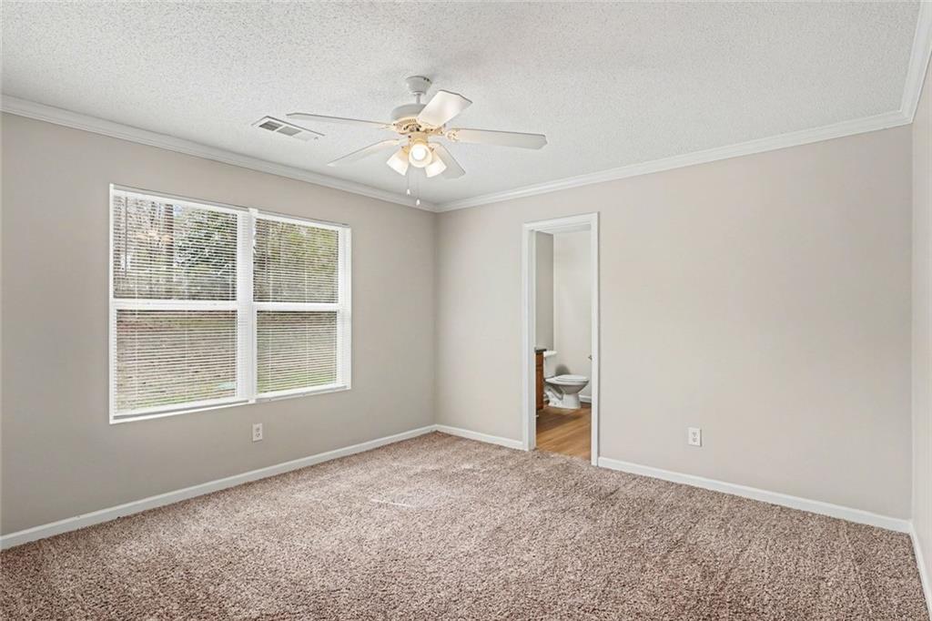 85 Homestead Place Rex, GA 30273 - Photo 12 of 17 an empty room with windows and fan