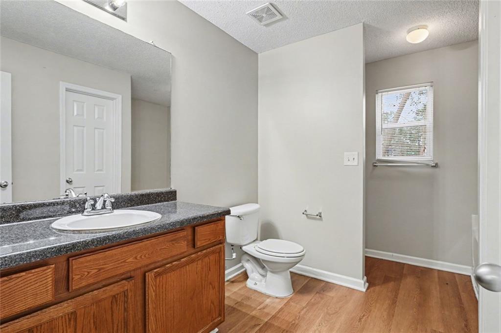 85 Homestead Place Rex, GA 30273 - Photo 14 of 17 a bathroom with a granite countertop sink toilet and shower