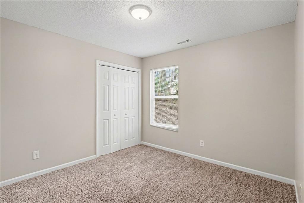 85 Homestead Place Rex, GA 30273 - Photo 7 of 17 an empty room with windows