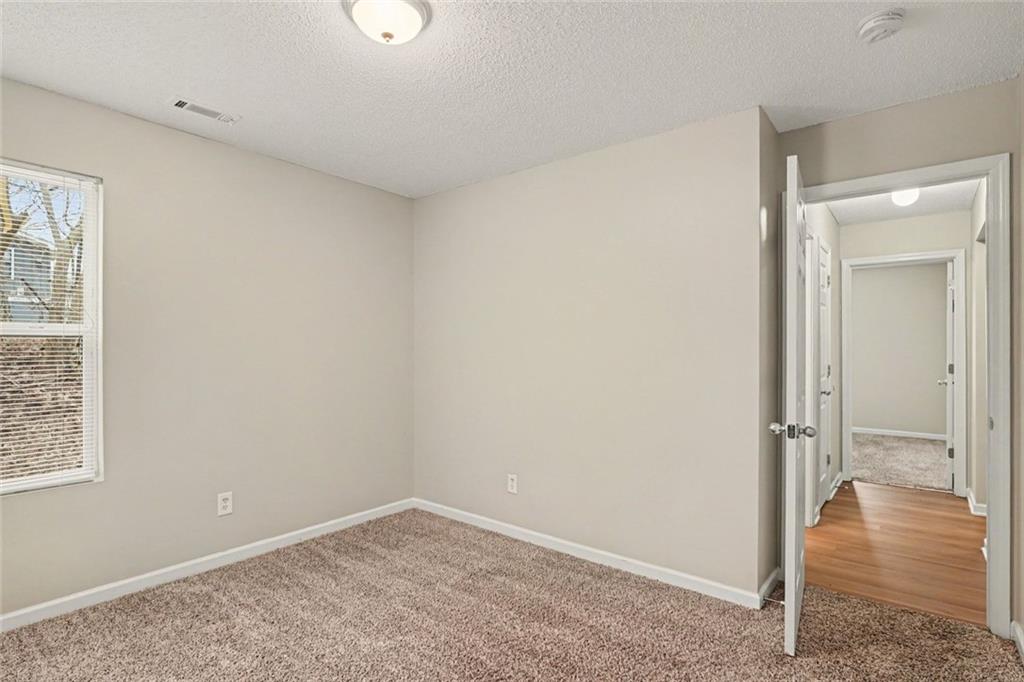 85 Homestead Place Rex, GA 30273 - Photo 8 of 17 an empty room with wooden floor and a window