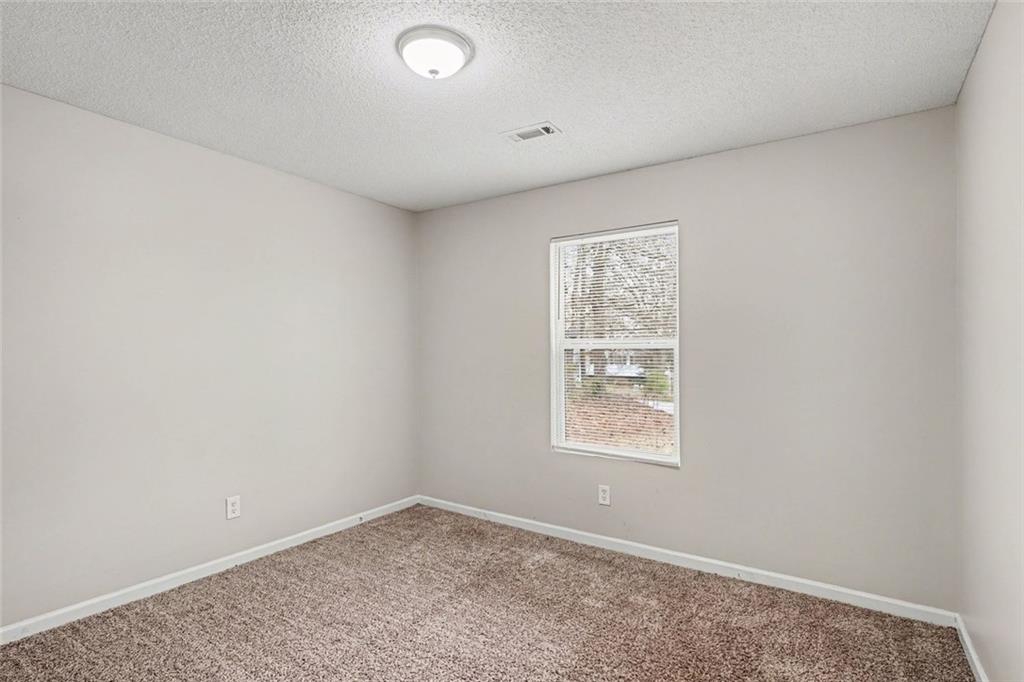 85 Homestead Place Rex, GA 30273 - Photo 10 of 17 an empty room with a window