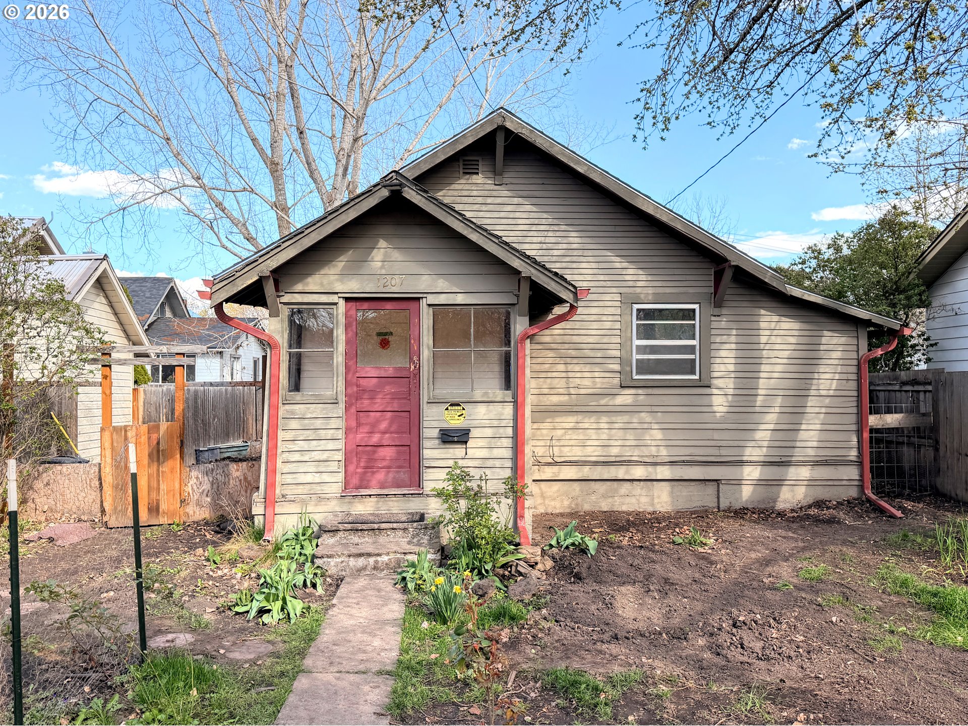 1207 10th Street La Grande, OR 97850 - Photo 1 of 13 a front view of a house with garden