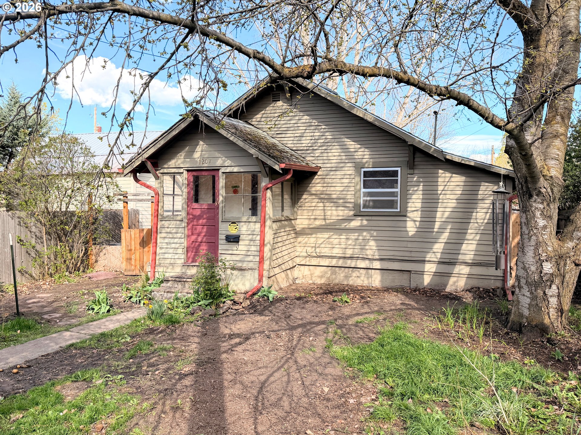 1207 10th Street La Grande, OR 97850 - Photo 12 of 13 a front view of a house with a yard and garage