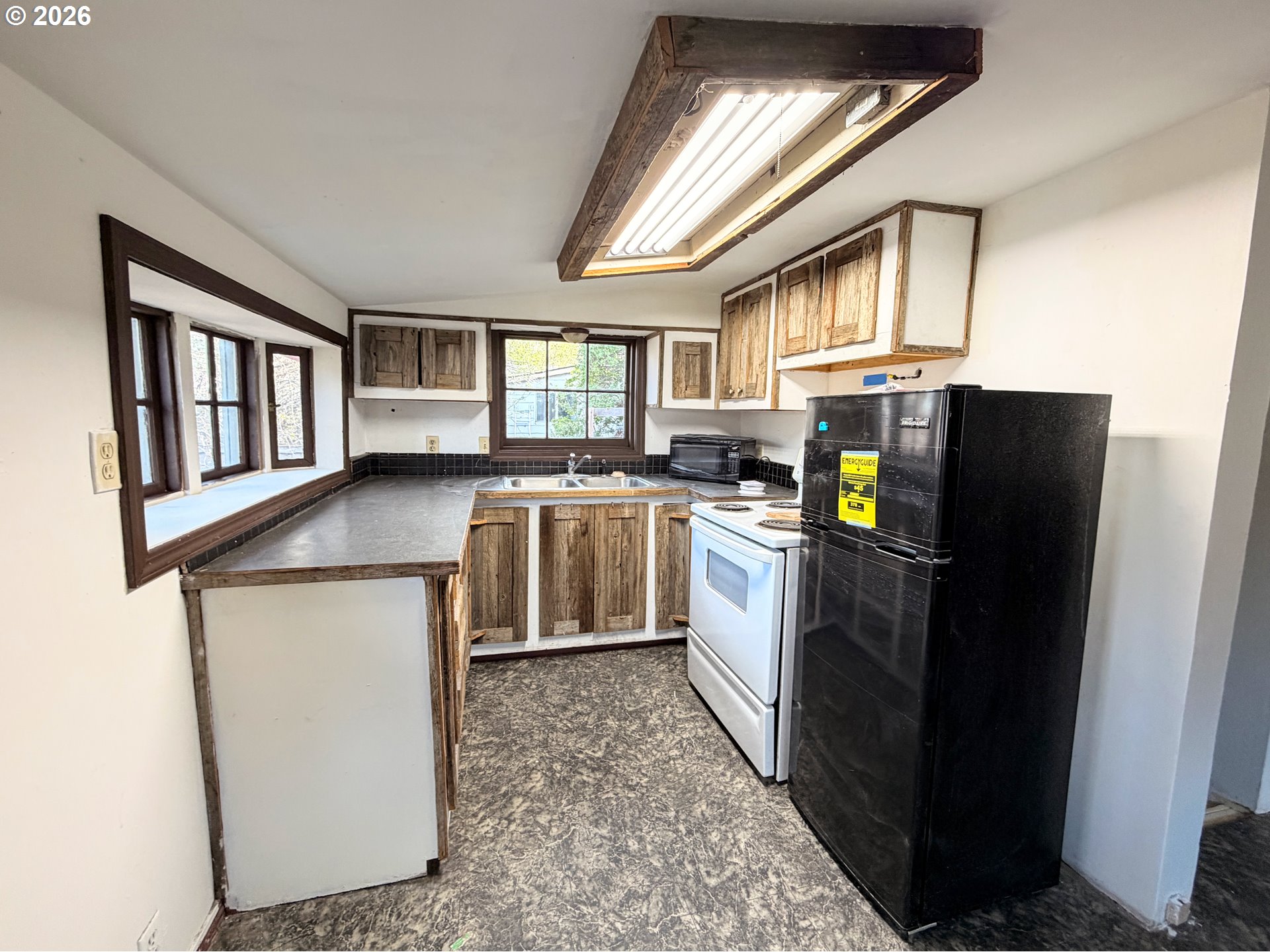 1207 10th Street La Grande, OR 97850 - Photo 6 of 13 a kitchen with a sink appliances and cabinets