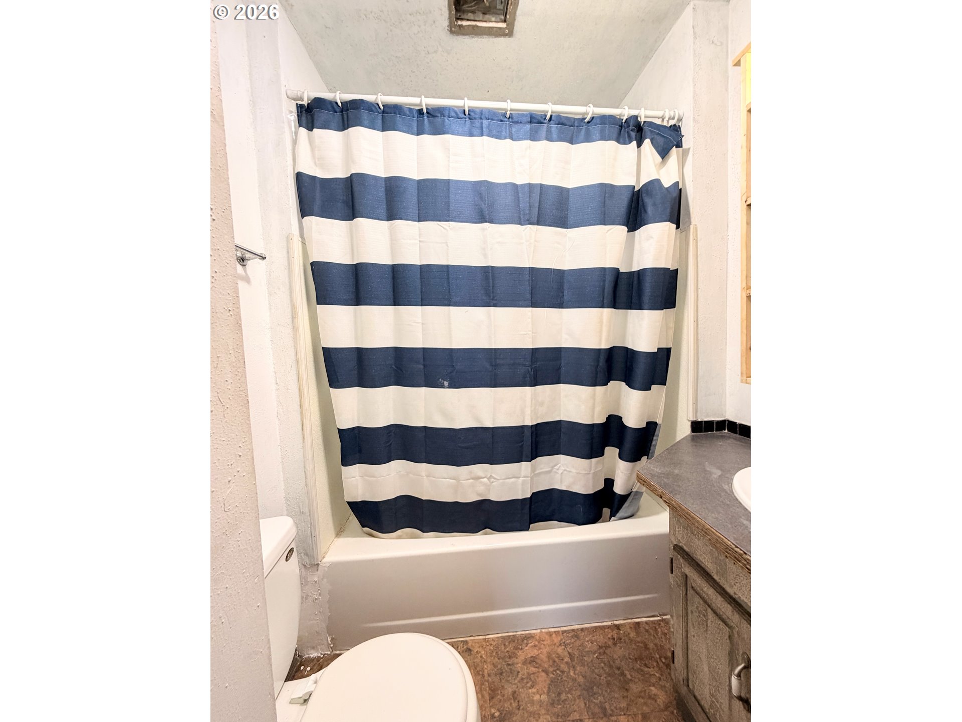 1207 10th Street La Grande, OR 97850 - Photo 8 of 13 a bathroom with a sink and toilet