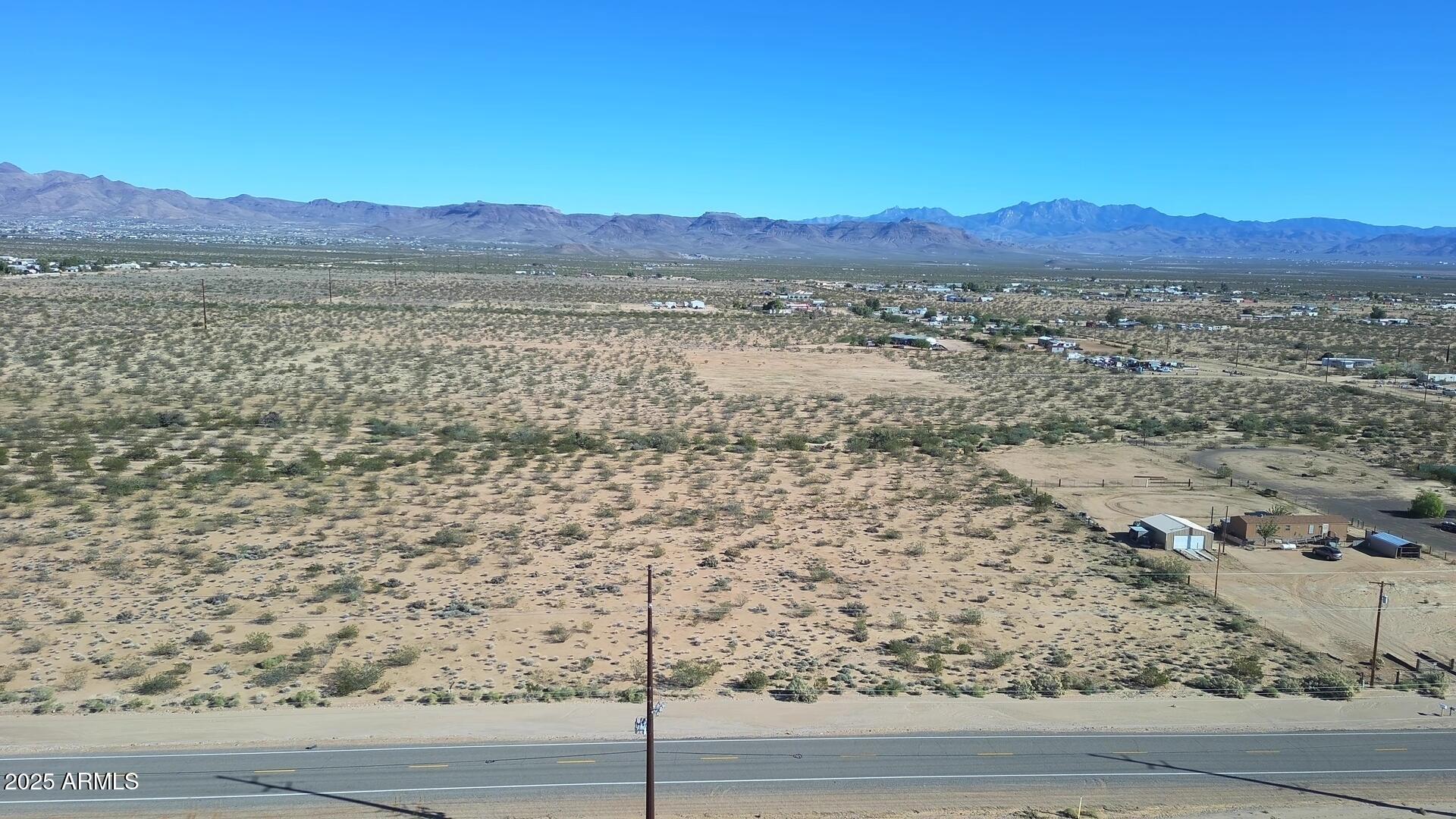 a view of mountain with sunset in background