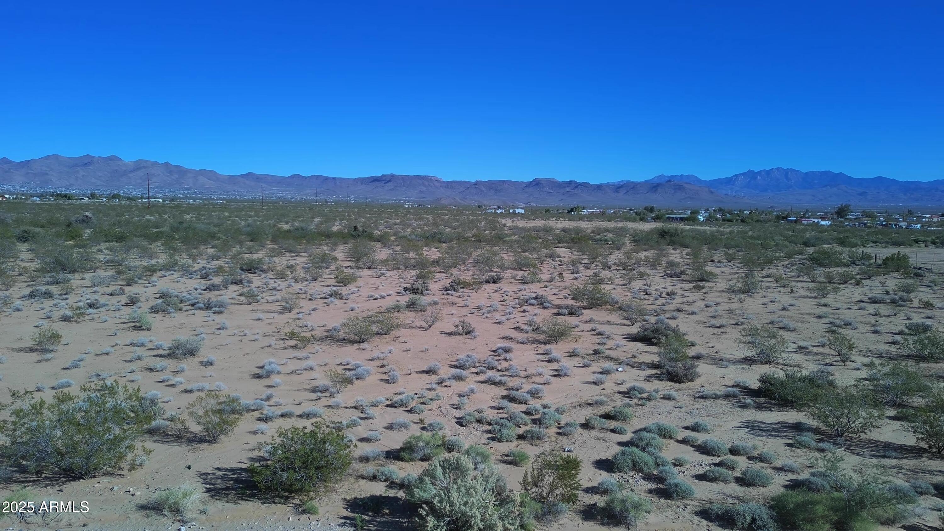 1152 Colorado Road Golden Valley, AZ 86413 - Photo 25 of 47 a view of a large body of water with lots of trees in the background
