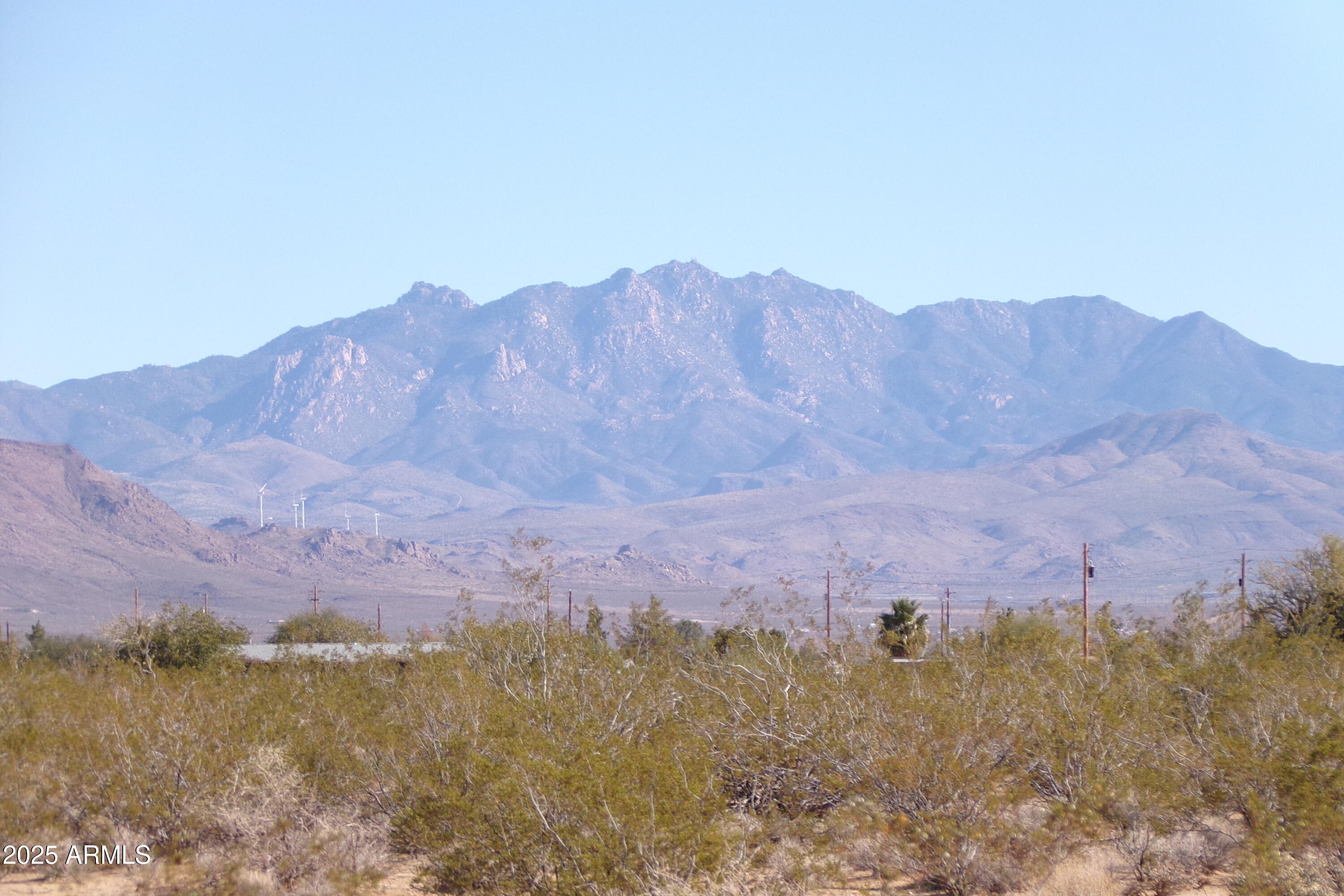 1152 Colorado Road Golden Valley, AZ 86413 - Photo 31 of 47 a view of a dry field with mountains in the background