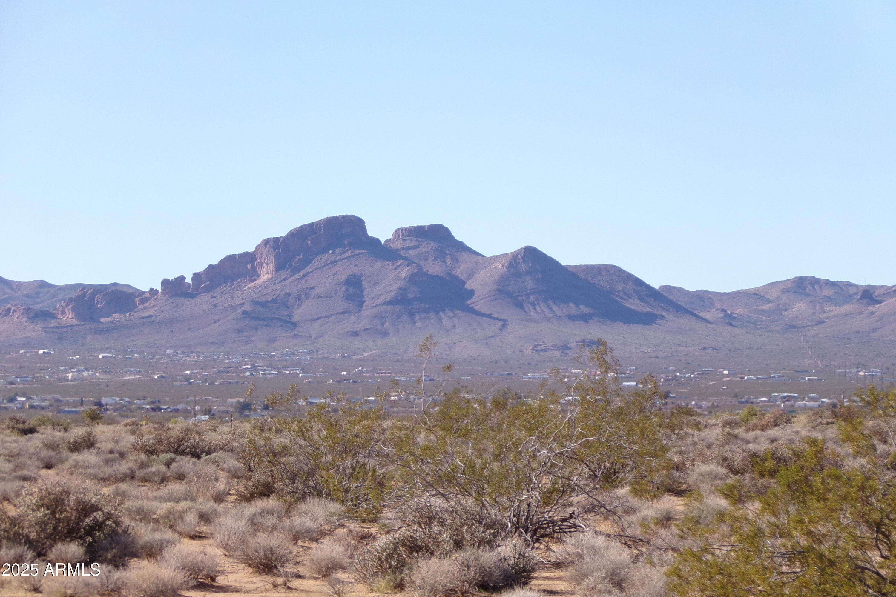 1152 Colorado Road Golden Valley, AZ 86413 - Photo 32 of 47 a view of a house with a mountain in the background