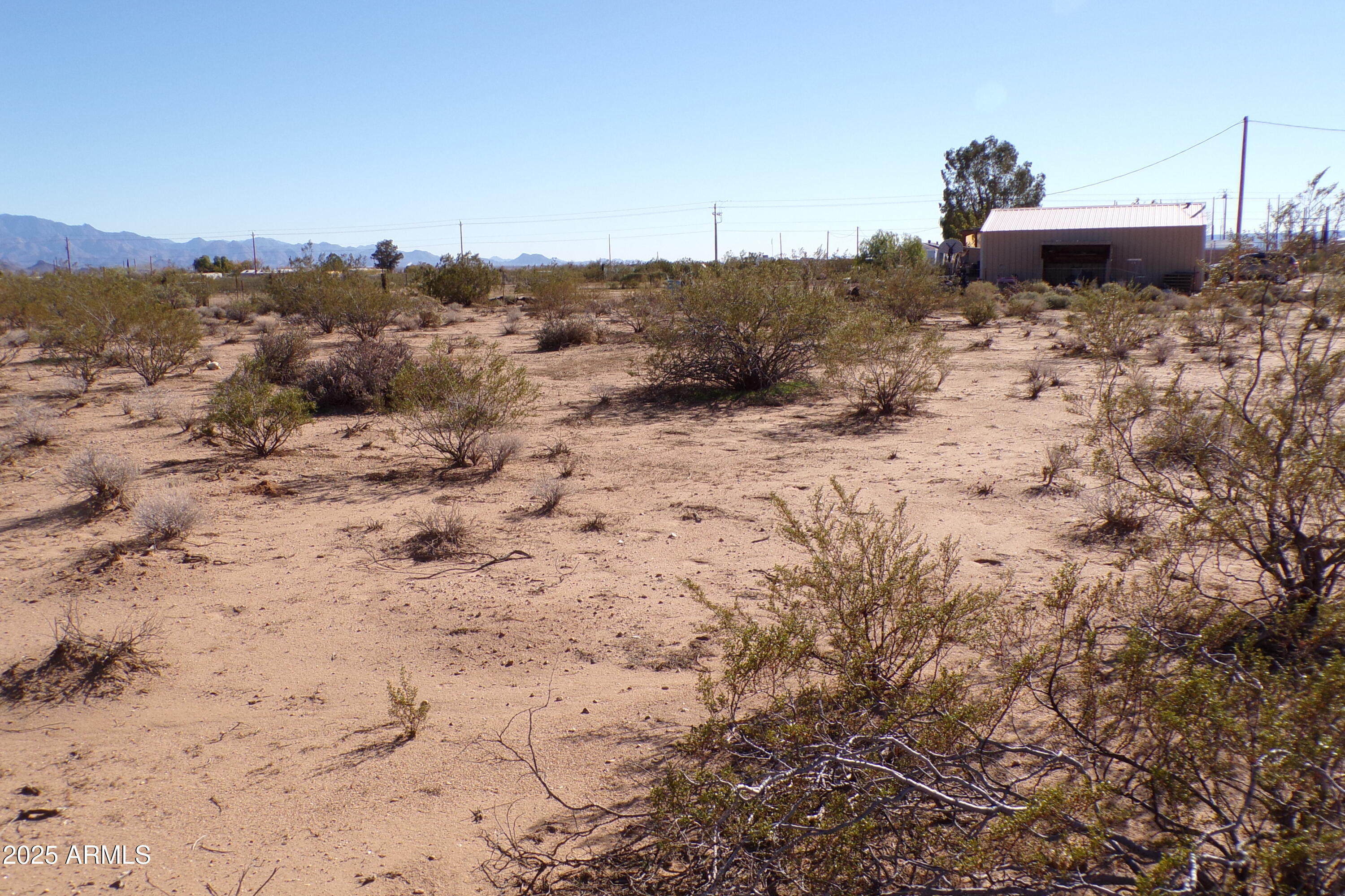 1152 Colorado Road Golden Valley, AZ 86413 - Photo 41 of 47 a view of a dry yard with wooden fence