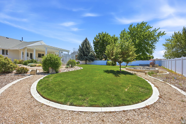 776 Flint Street Layton, UT 84041 - Photo 29 of 41 Manicured lawn with concrete-edged gravel pathways