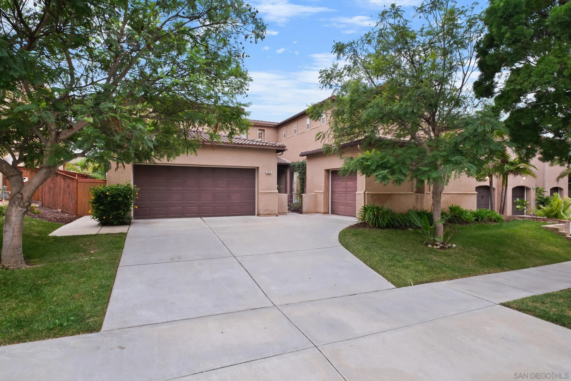a front view of a house with a yard and a garage