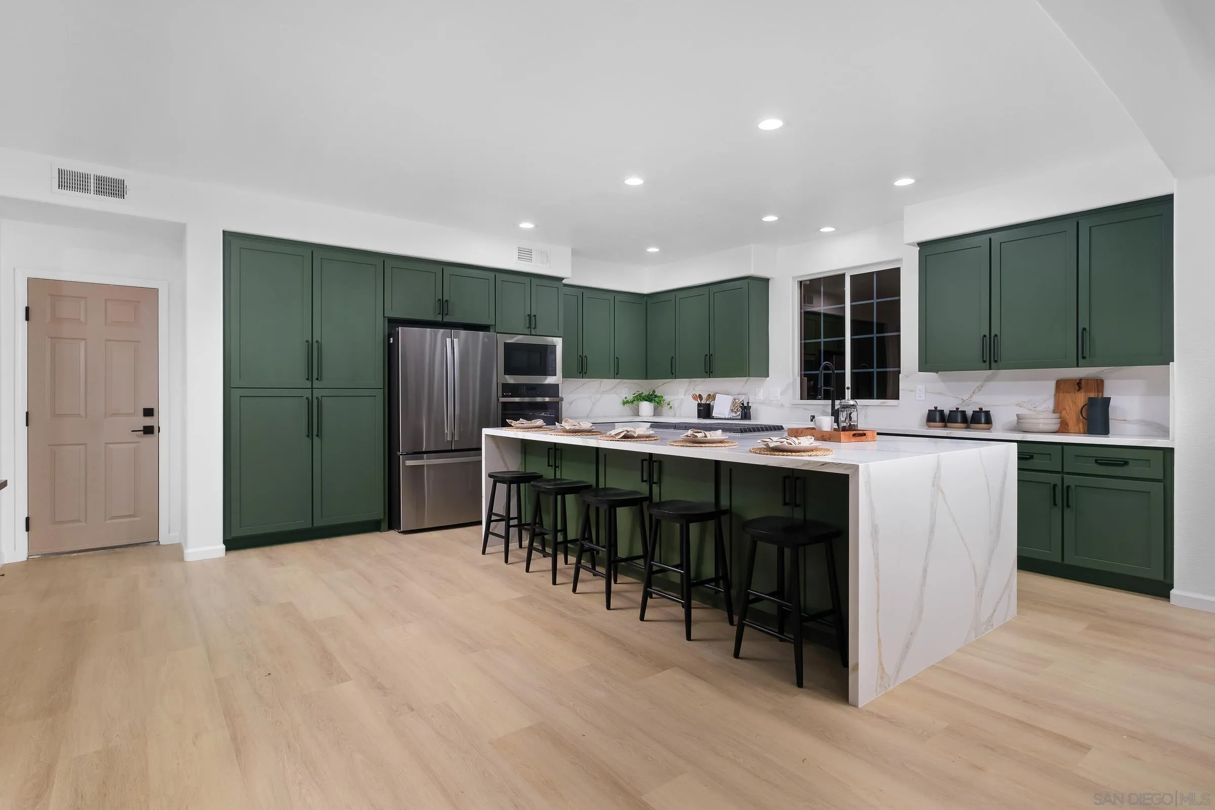 550 Echo Lane San Marcos, CA 92078 - Photo 19 of 51 a kitchen with kitchen island a sink stainless steel appliances and cabinets