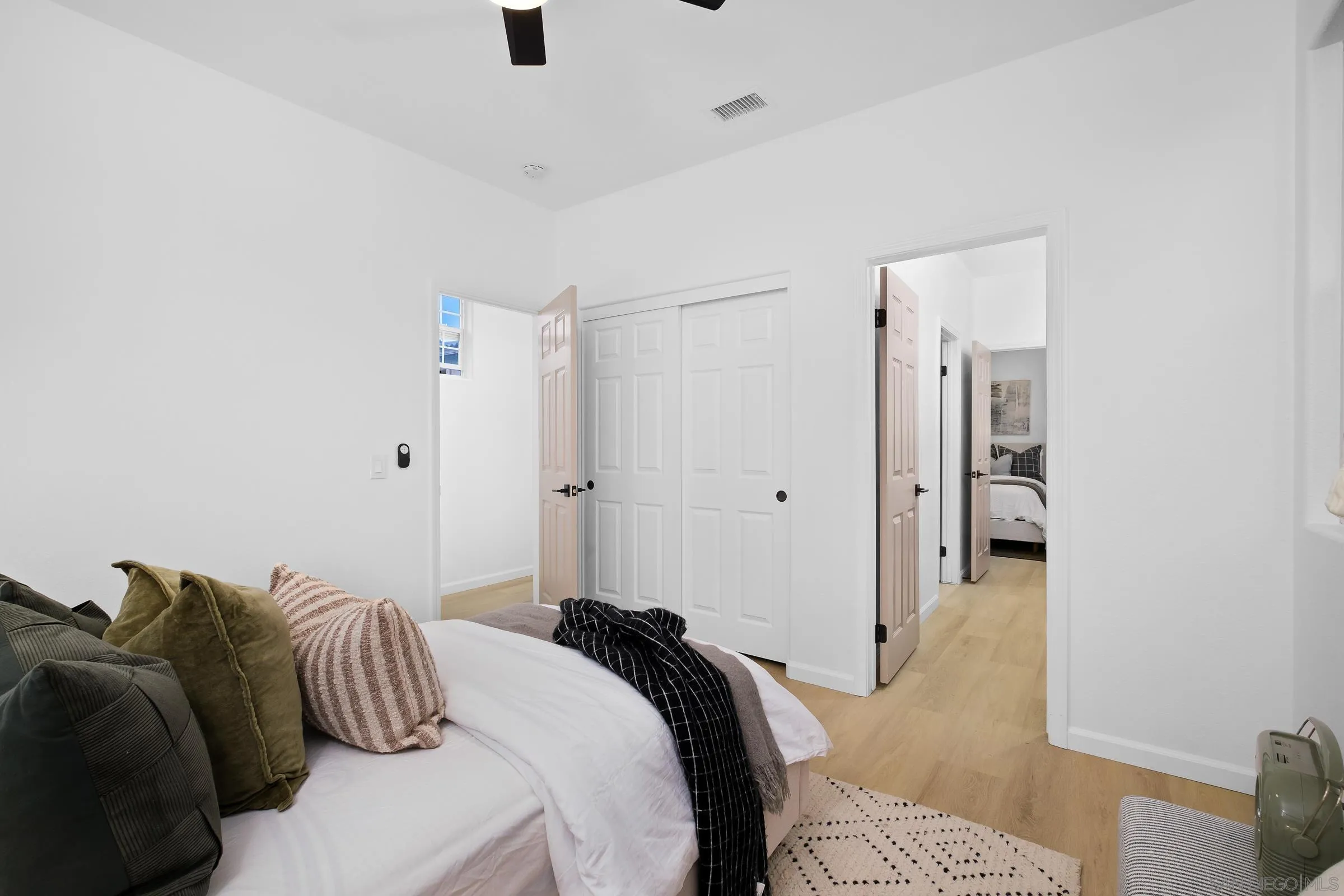 550 Echo Lane San Marcos, CA 92078 - Photo 25 of 51 a bedroom with a bed and a chandelier