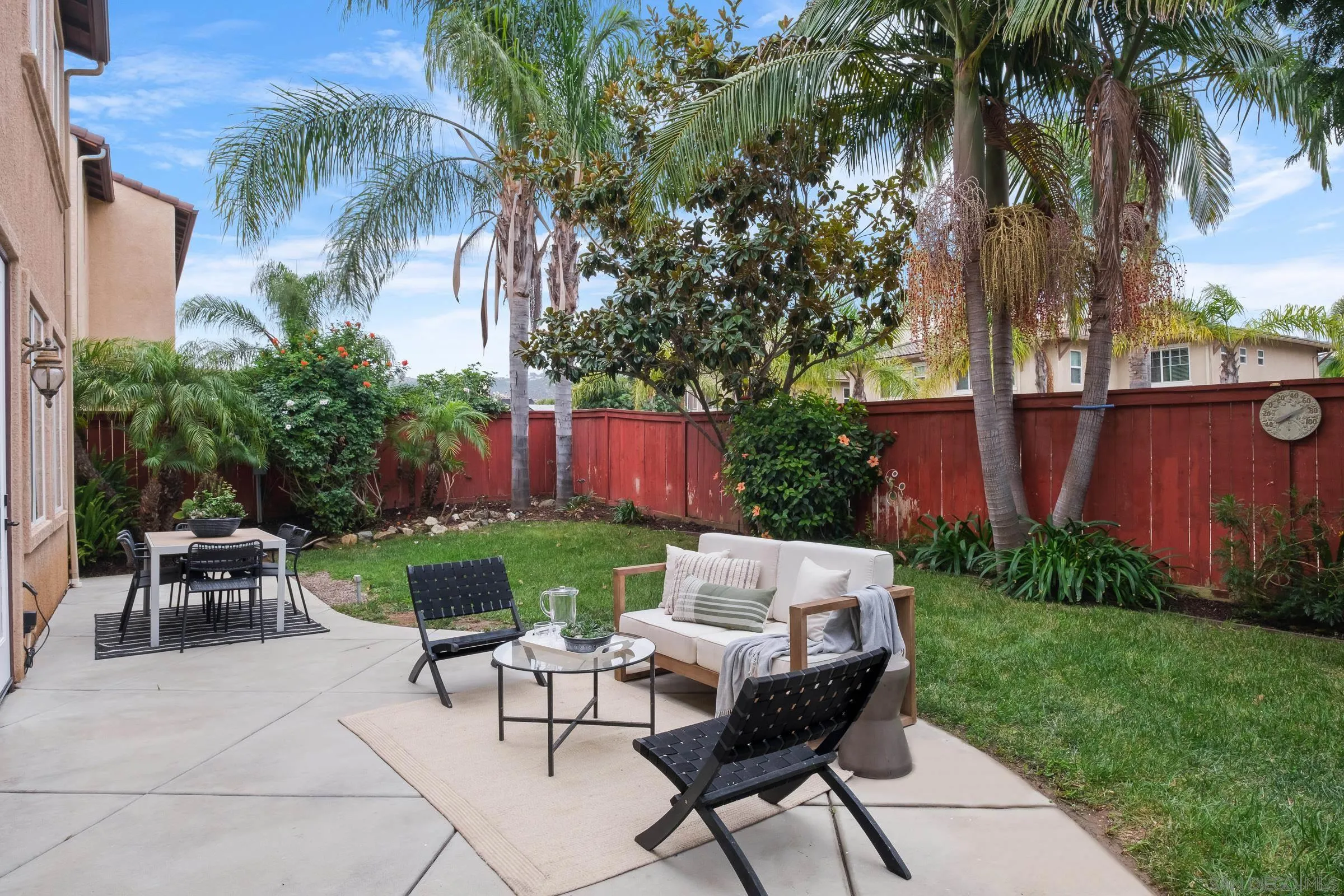 550 Echo Lane San Marcos, CA 92078 - Photo 40 of 51 a view of a backyard with table and chairs potted plants and palm tree
