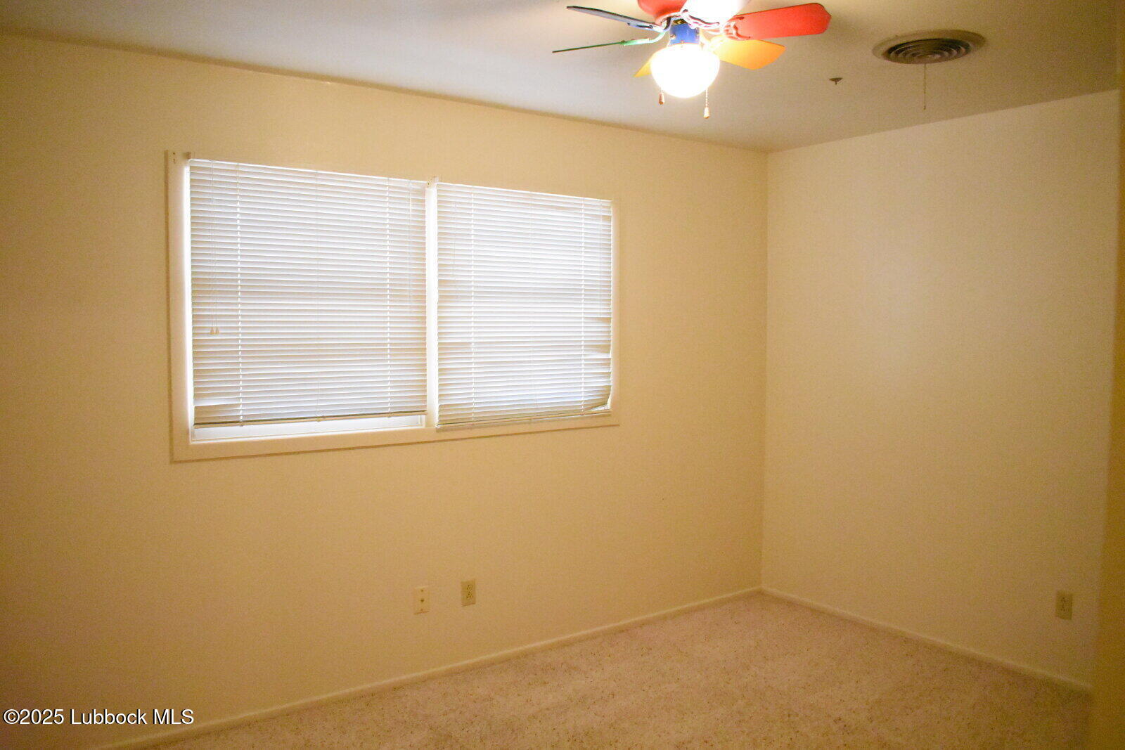 2008 54th Street Lubbock, TX 79412 - Photo 12 of 14 an empty room with a window and a ceiling fan