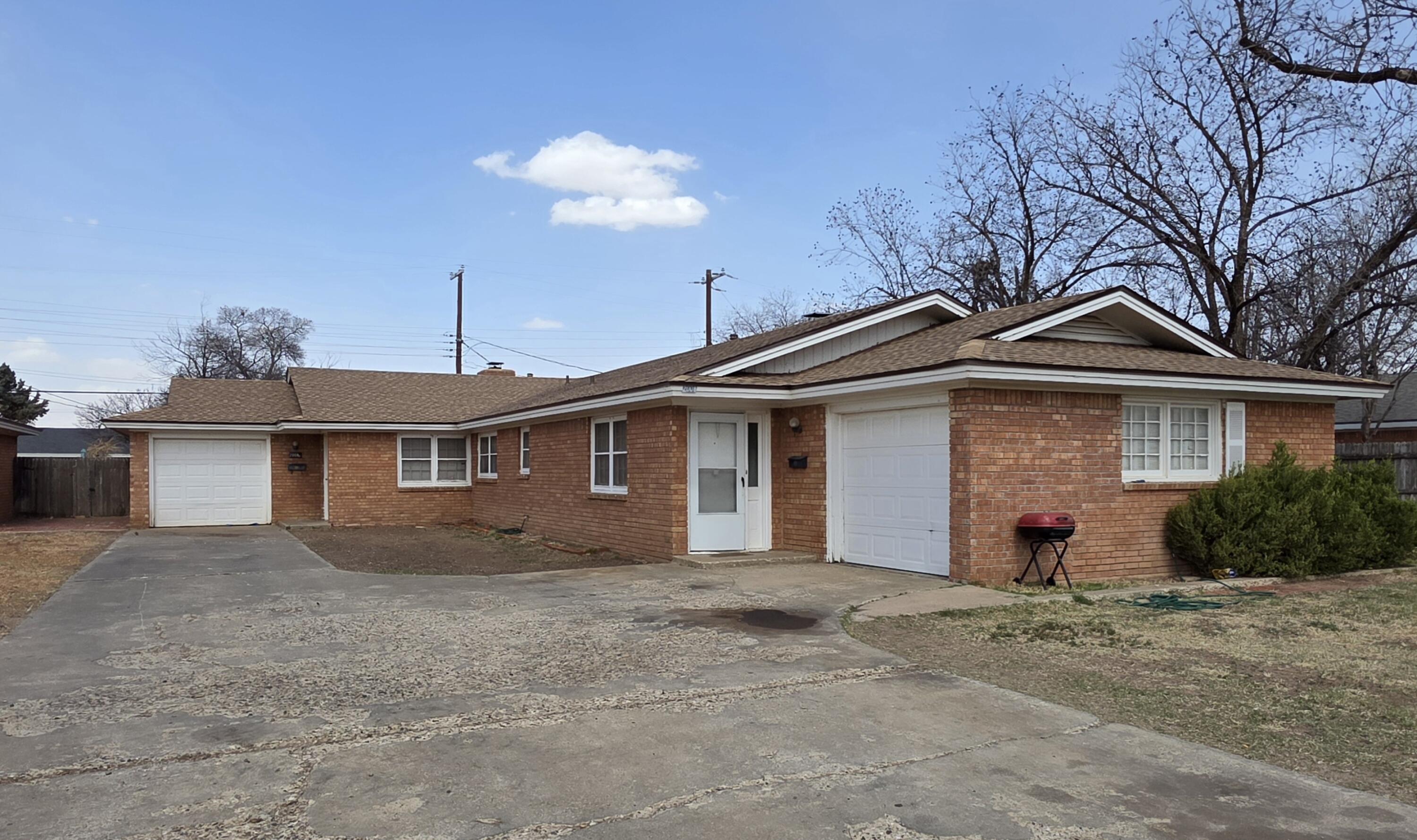 2008 54th Street Lubbock, TX 79412 - Photo 4 of 14 a front view of a house with a yard