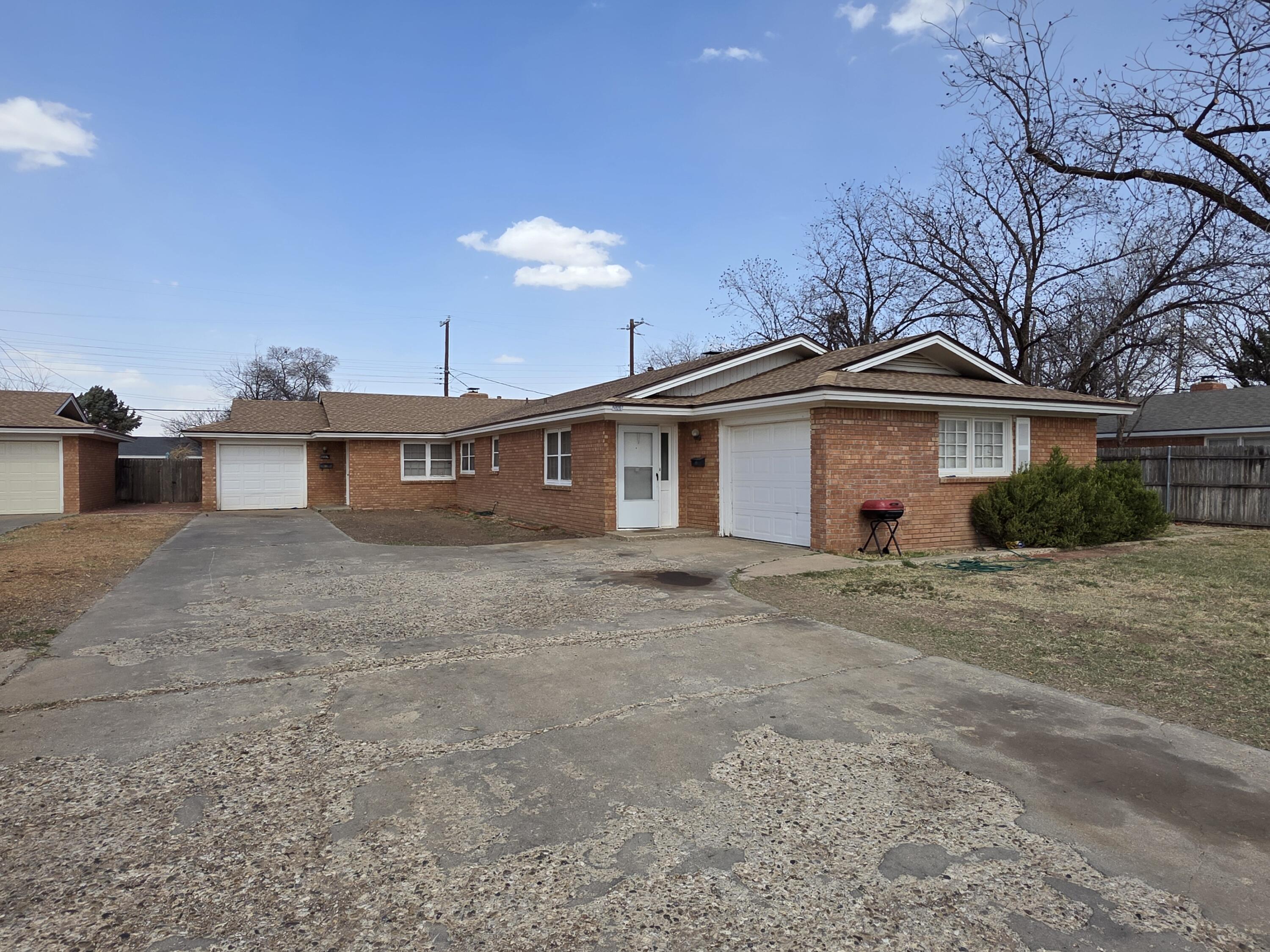 2008 54th Street Lubbock, TX 79412 - Photo 5 of 14 a front view of a house with a yard and garage