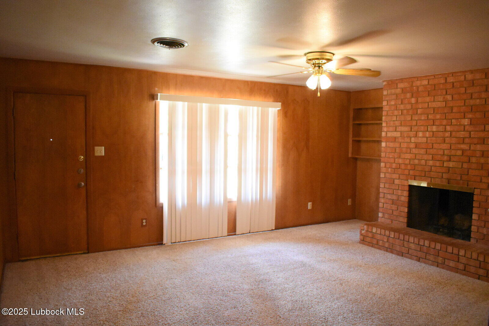 2008 54th Street Lubbock, TX 79412 - Photo 6 of 14 a view of an empty room with a fireplace