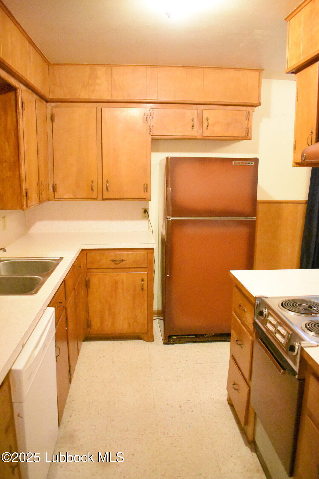 2008 54th Street Lubbock, TX 79412 - Photo 9 of 14 a kitchen with a sink and a refrigerator