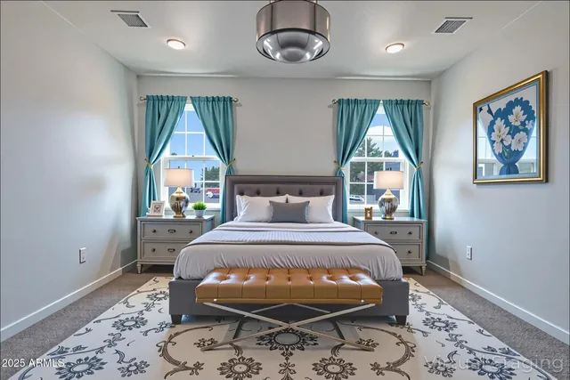 a bed sitting in a bedroom next to a window