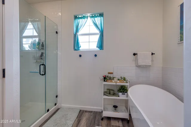 a bathroom with a bathtub sink and mirror