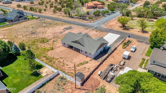 an aerial view of a house a yard and mountain