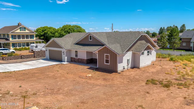 a house with tall trees in the background
