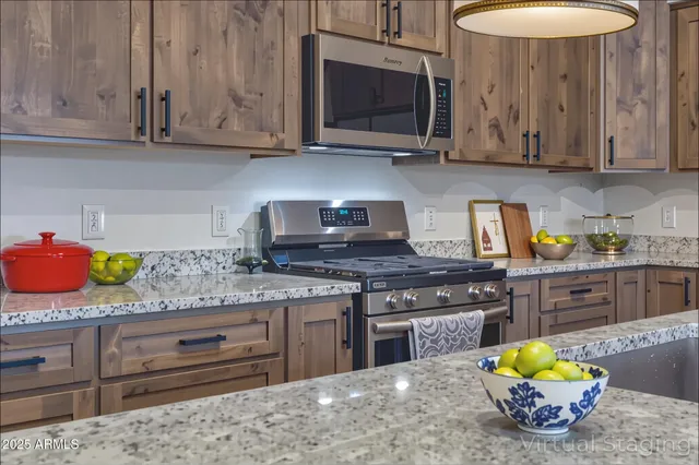 a kitchen with granite countertop a stove a oven a sink dishwasher and cabinets with wooden floor