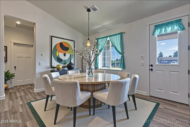 a view of a dining room with furniture wooden floor and a chandelier