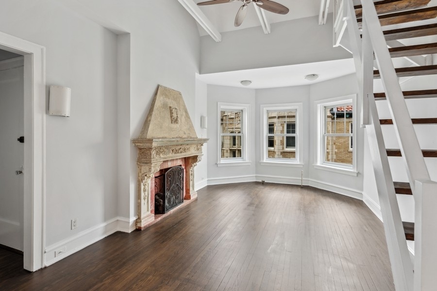 534 West Brompton Avenue, Unit 3N Chicago, IL 60657 - Photo 3 of 19 a view of an empty room with fireplace and wooden floor