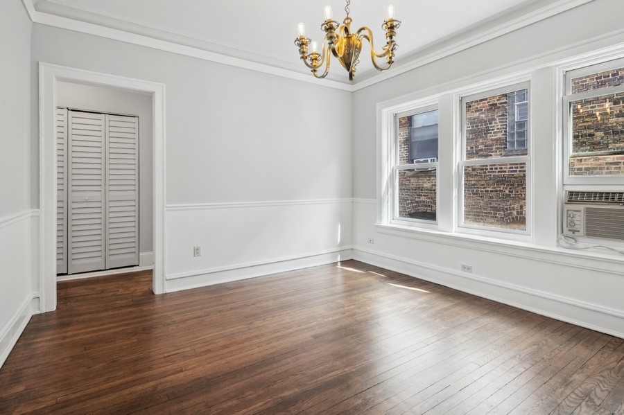 534 West Brompton Avenue, Unit 3N Chicago, IL 60657 - Photo 6 of 19 an empty room with wooden floor and windows