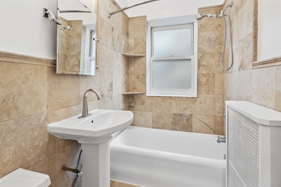 534 West Brompton Avenue, Unit 3N Chicago, IL 60657 - Photo 9 of 19 a bathroom with a sink a toilet and shower