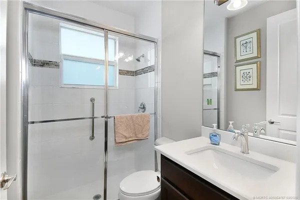 a utility room with cabinets washer and dryer