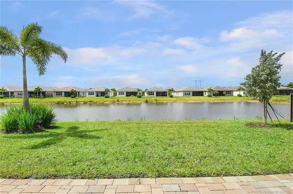 an aerial view of residential houses with outdoor space and parking