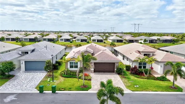an aerial view of a house with swimming pool garden and patio
