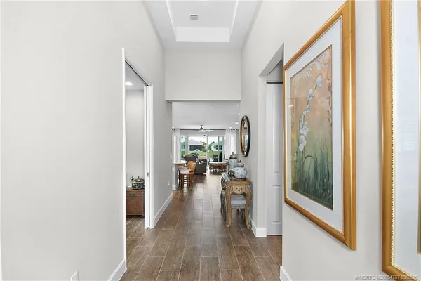 a living room with furniture kitchen view and a large window
