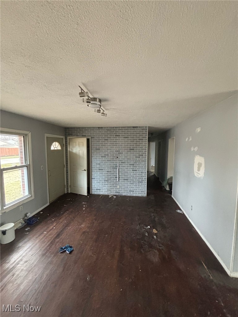 5930 Lake Road Mentor, OH 44060 - Photo 10 of 11 Unfurnished living room with wood finished floors and a textured ceiling