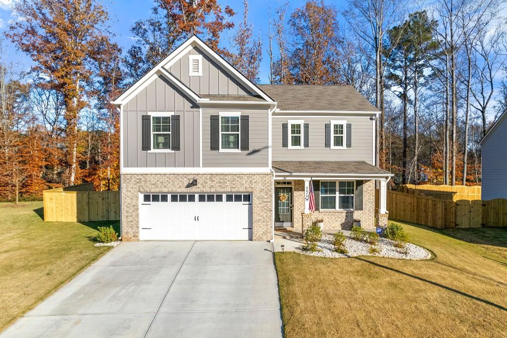 4878 Golden Finch Lane Powder Springs, GA 30127 - Photo 1 of 1 a front view of a house with a yard and garage