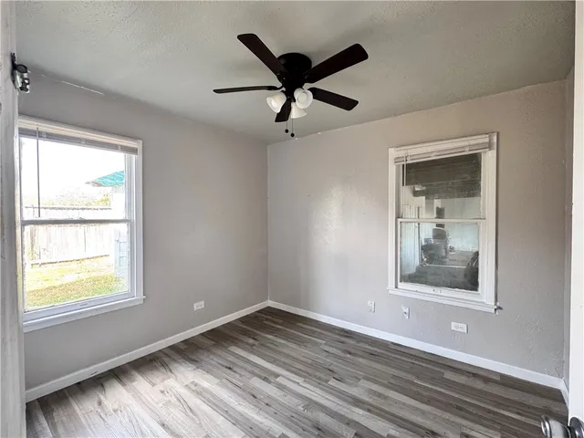a view of wooden floor and a window in a room