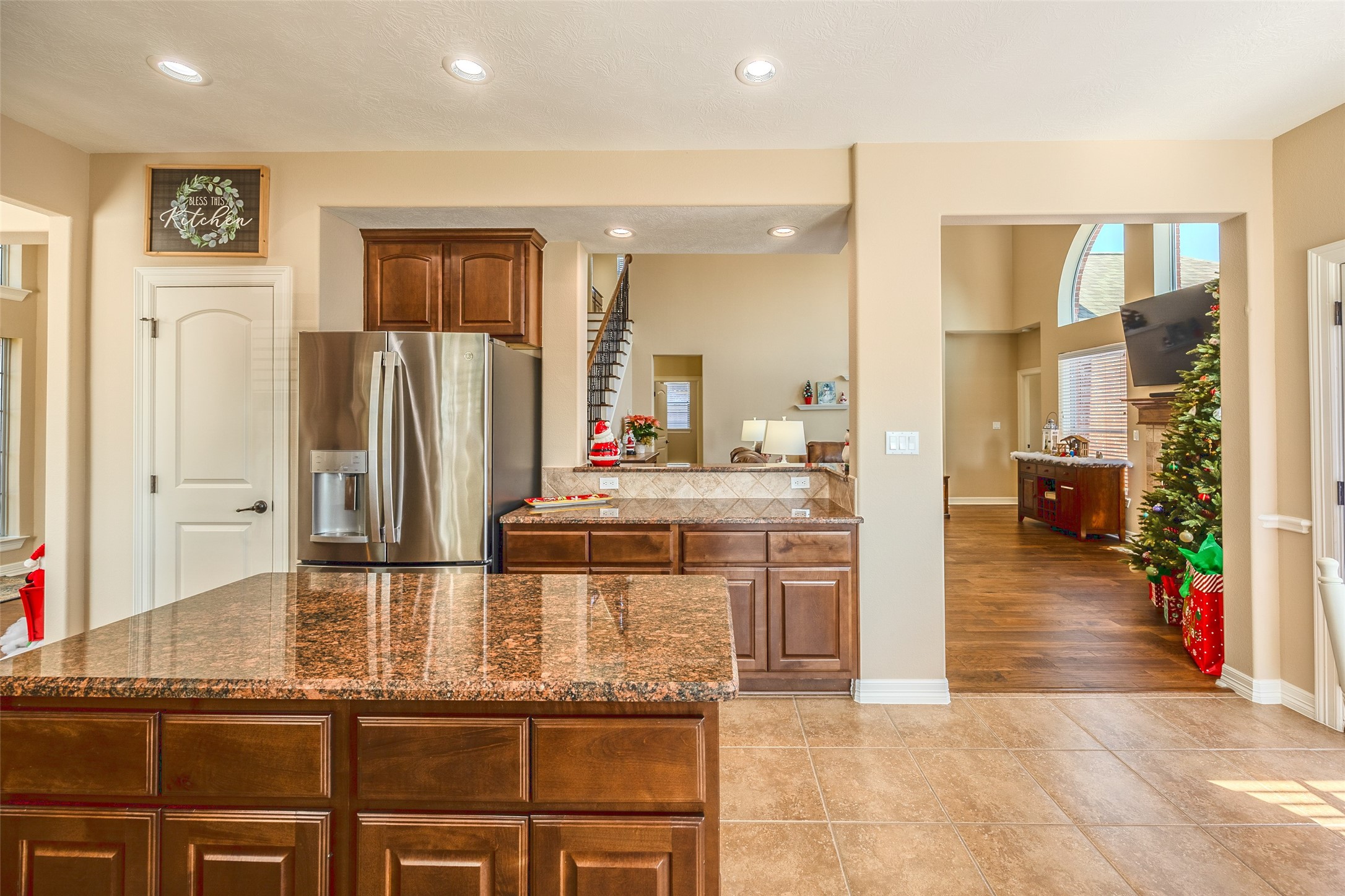 1905 Rosenbaum Drive Brenham, TX 77833 - Photo 14 of 30 a kitchen with kitchen island granite countertop a refrigerator and cabinets