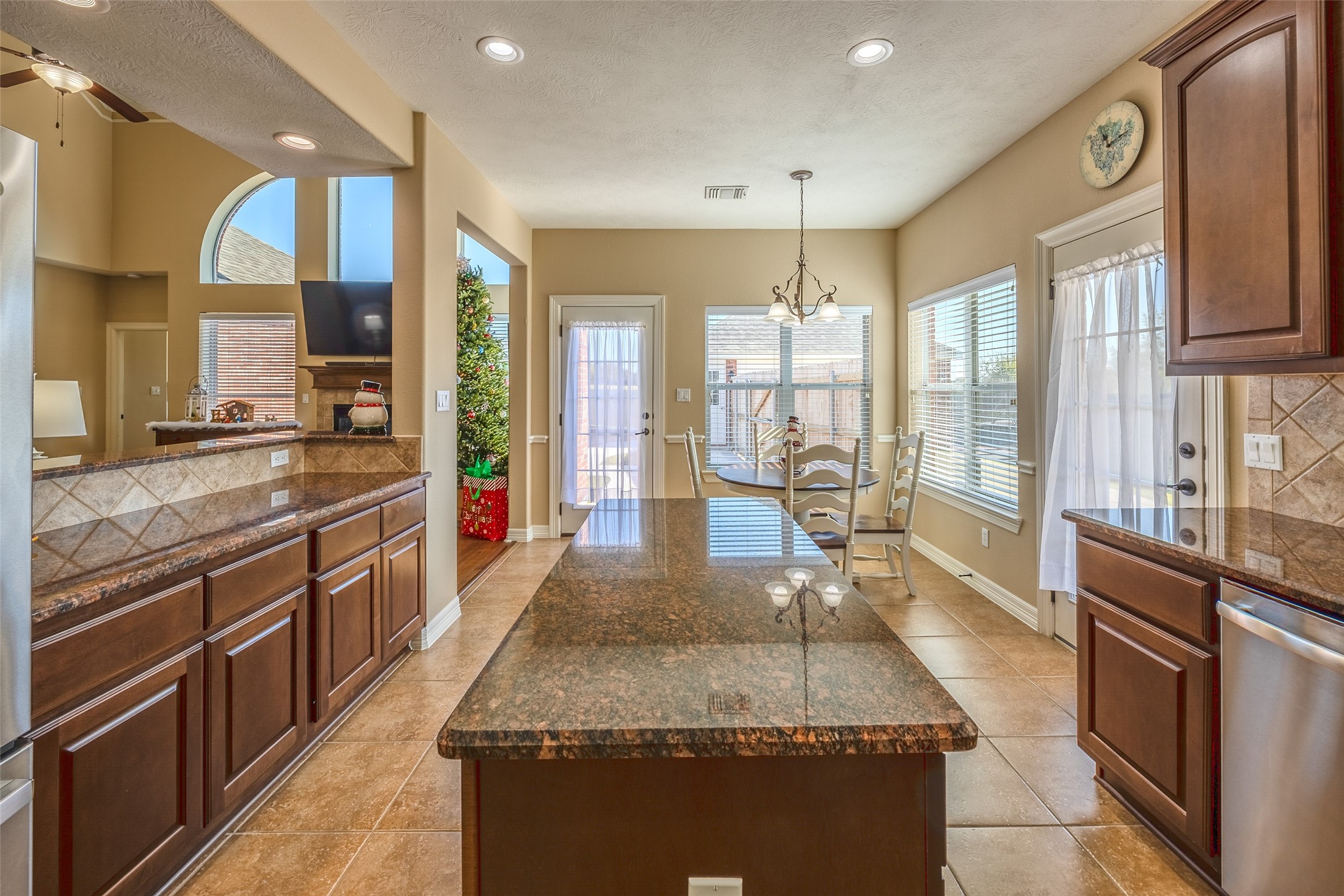 1905 Rosenbaum Drive Brenham, TX 77833 - Photo 16 of 30 a large kitchen with kitchen island granite countertop a large window and a sink