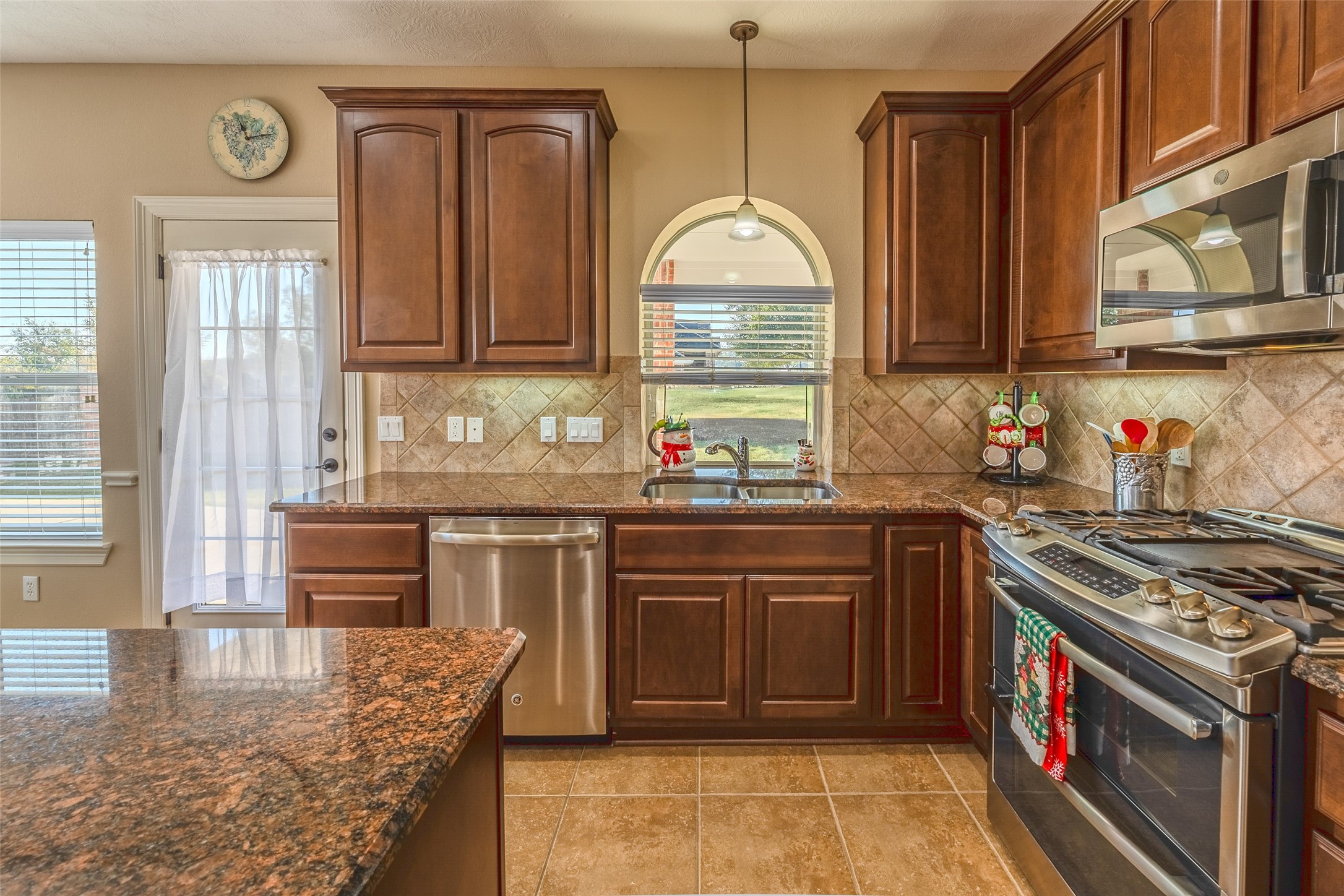 1905 Rosenbaum Drive Brenham, TX 77833 - Photo 17 of 30 a kitchen with stainless steel appliances granite countertop a stove a sink and a microwave