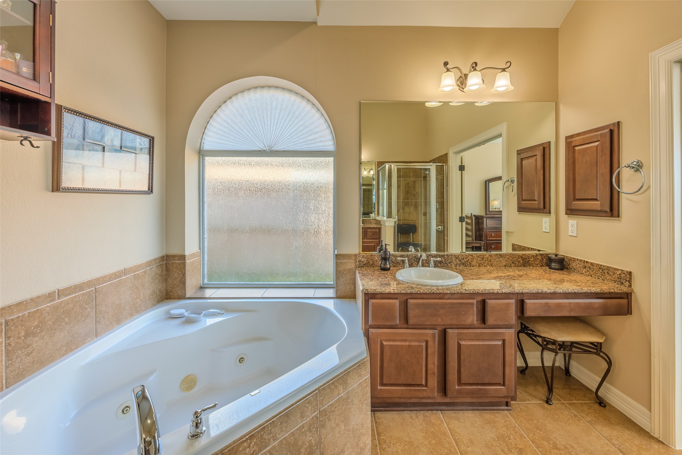 1905 Rosenbaum Drive Brenham, TX 77833 - Photo 21 of 30 a bathroom with a tub a double vanity sink and mirror