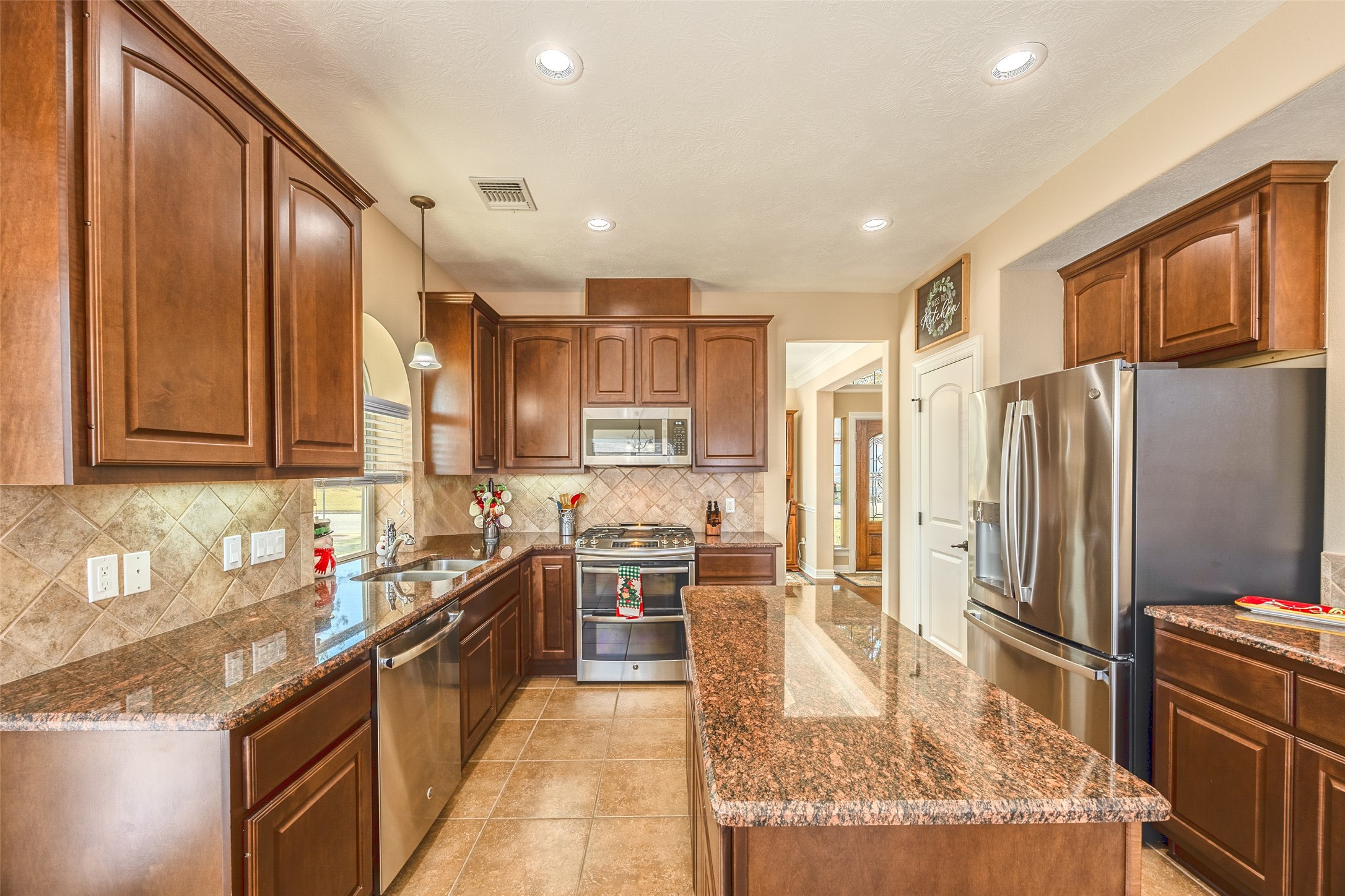 1905 Rosenbaum Drive Brenham, TX 77833 - Photo 3 of 30 a kitchen with stainless steel appliances granite countertop sink stove refrigerator and cabinets