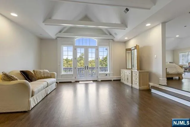 a living room with furniture pool table and a flat screen tv