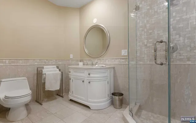 a bathroom with a toilet sink and a mirror