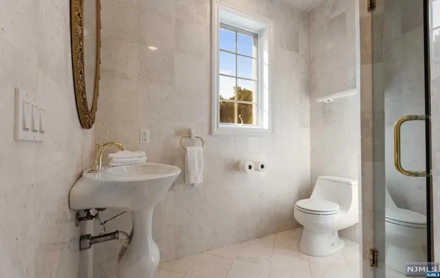 a bathroom with a toilet sink and mirror